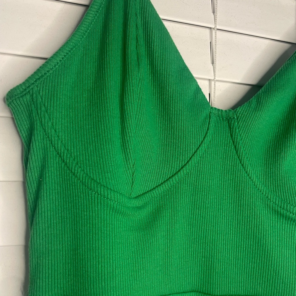 Green mini dress with spaghetti straps.